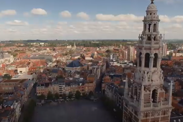 Aerial view of the city of Leuven with the main square and a tower.
